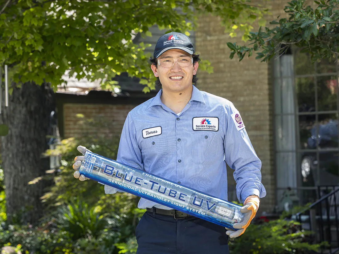 Service Experts Technician holding a Blue Tube UV Light