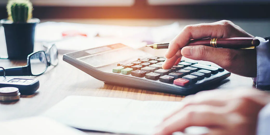 Businessman's hands with calculator and cost at the office and Financial data analyzing counting on wood desk