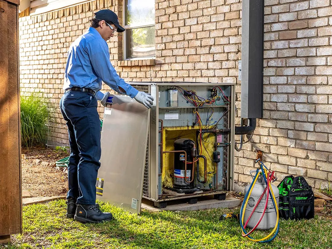 Service Experts technician performing AC maintenance