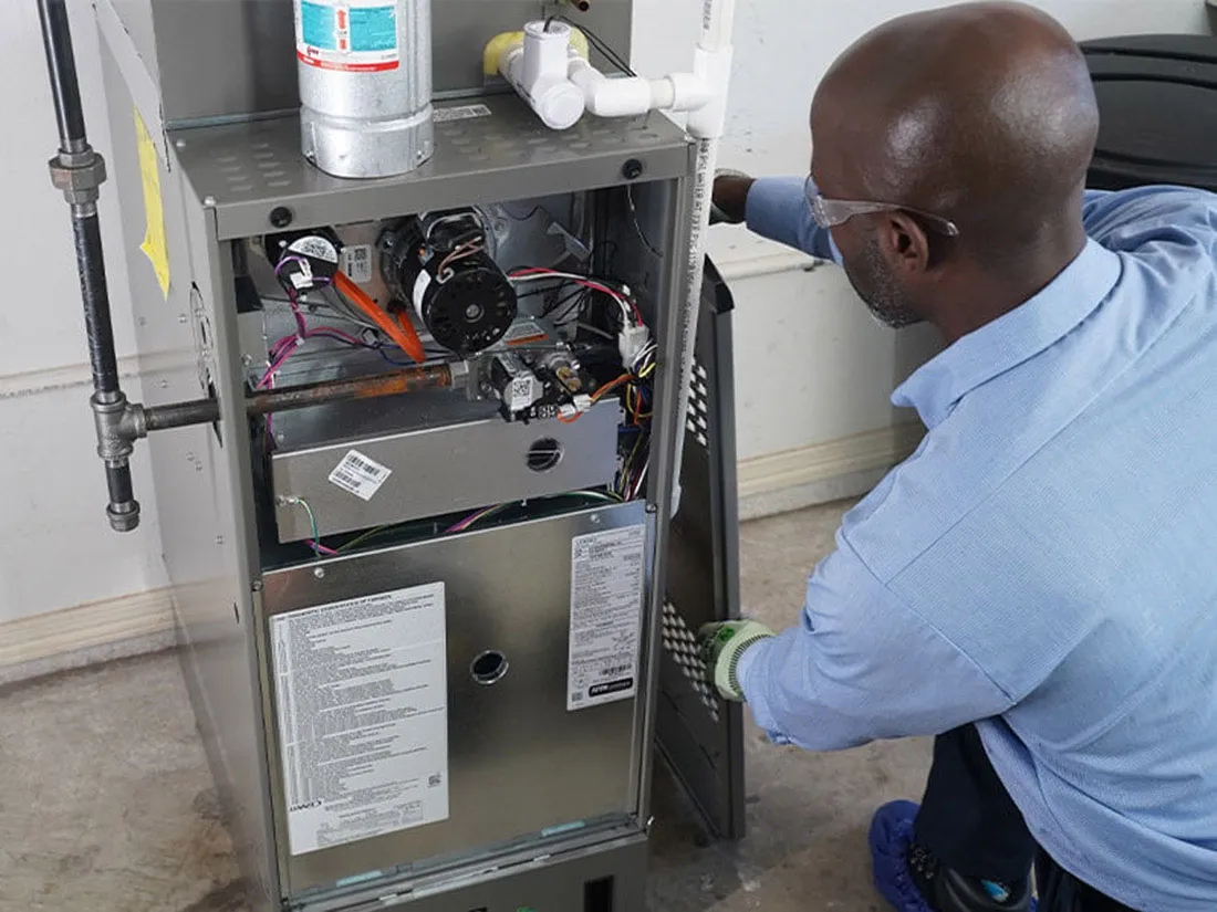 Service Experts technician installing a new furnace